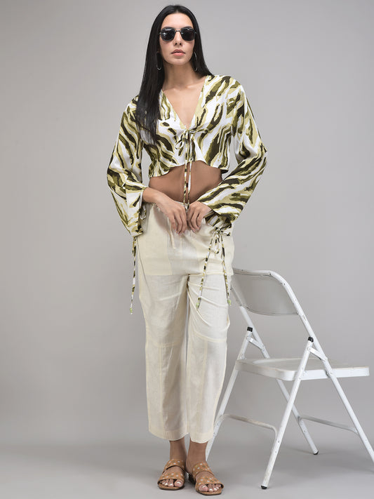 Chic olive green knotted top styled with white trousers – vacation outfit idea