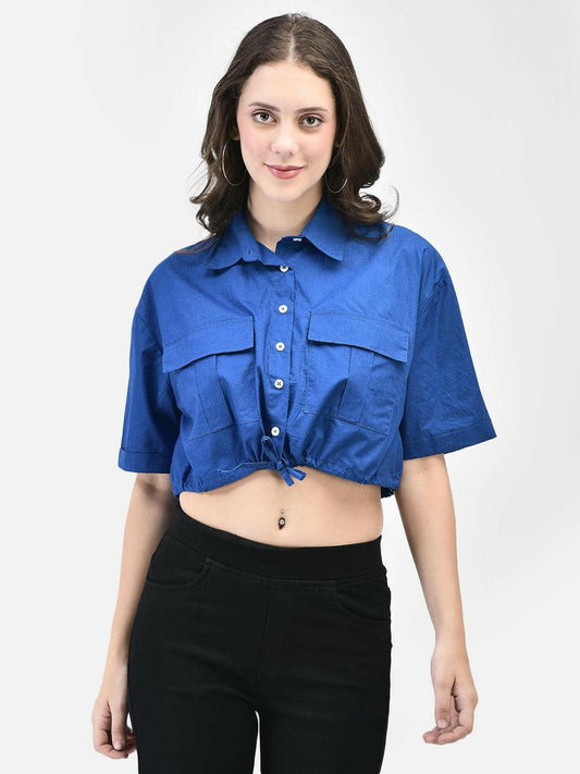 Straight pose of model in blue cotton midriff shirt and black pants