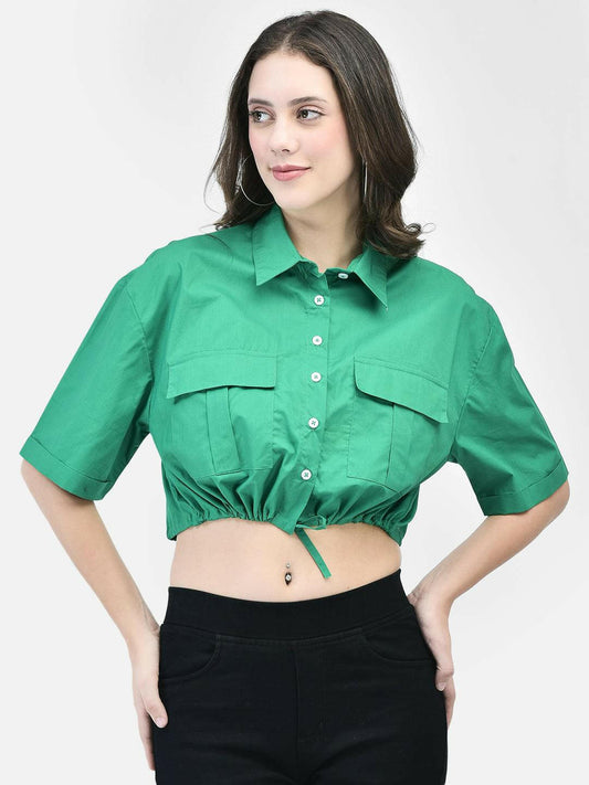 Model in green short-sleeve cropped shirt for women, button-down front, paired with black pants