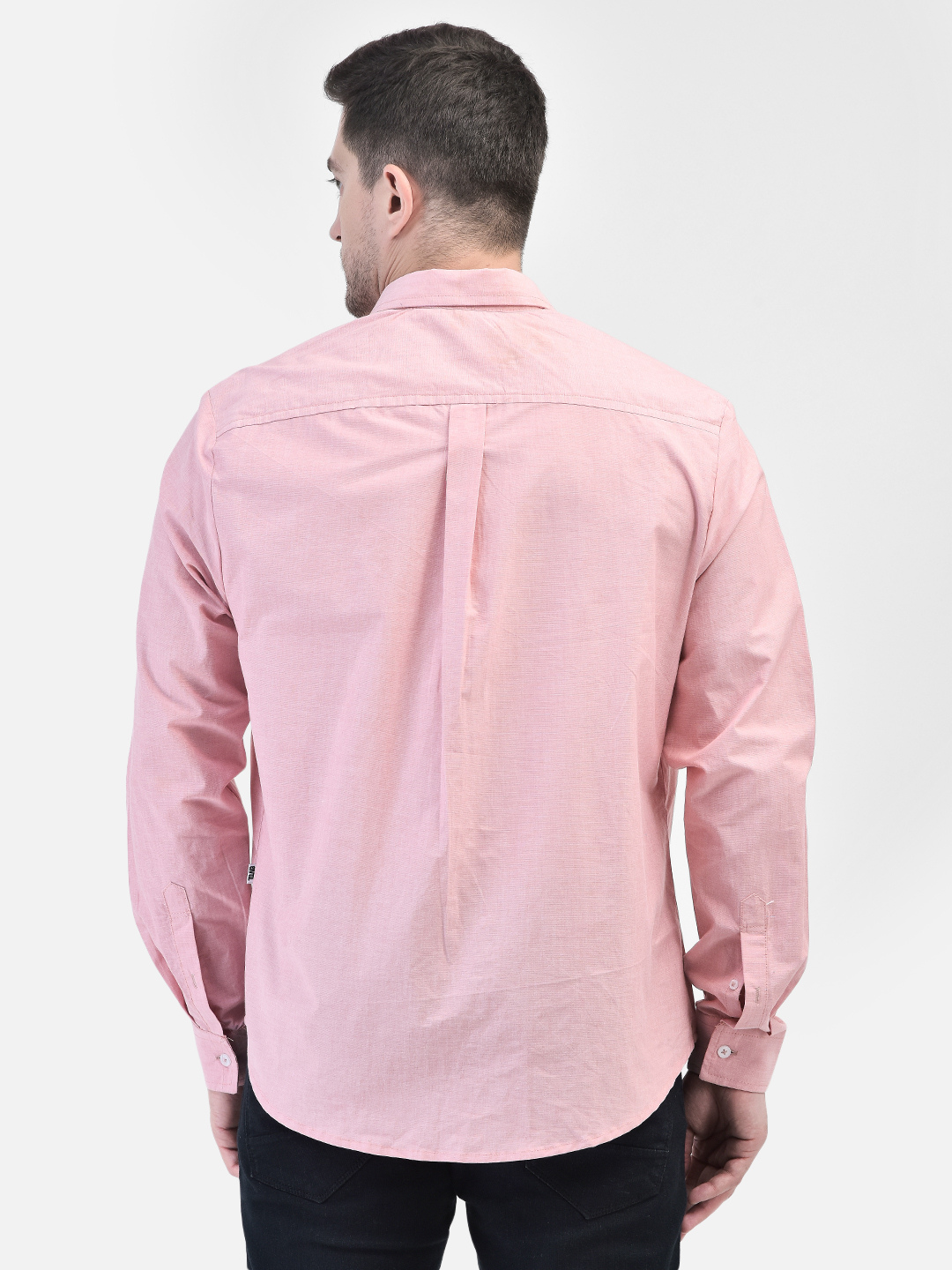 Back view of men’s pink casual shirt showing curved hemline and yoke