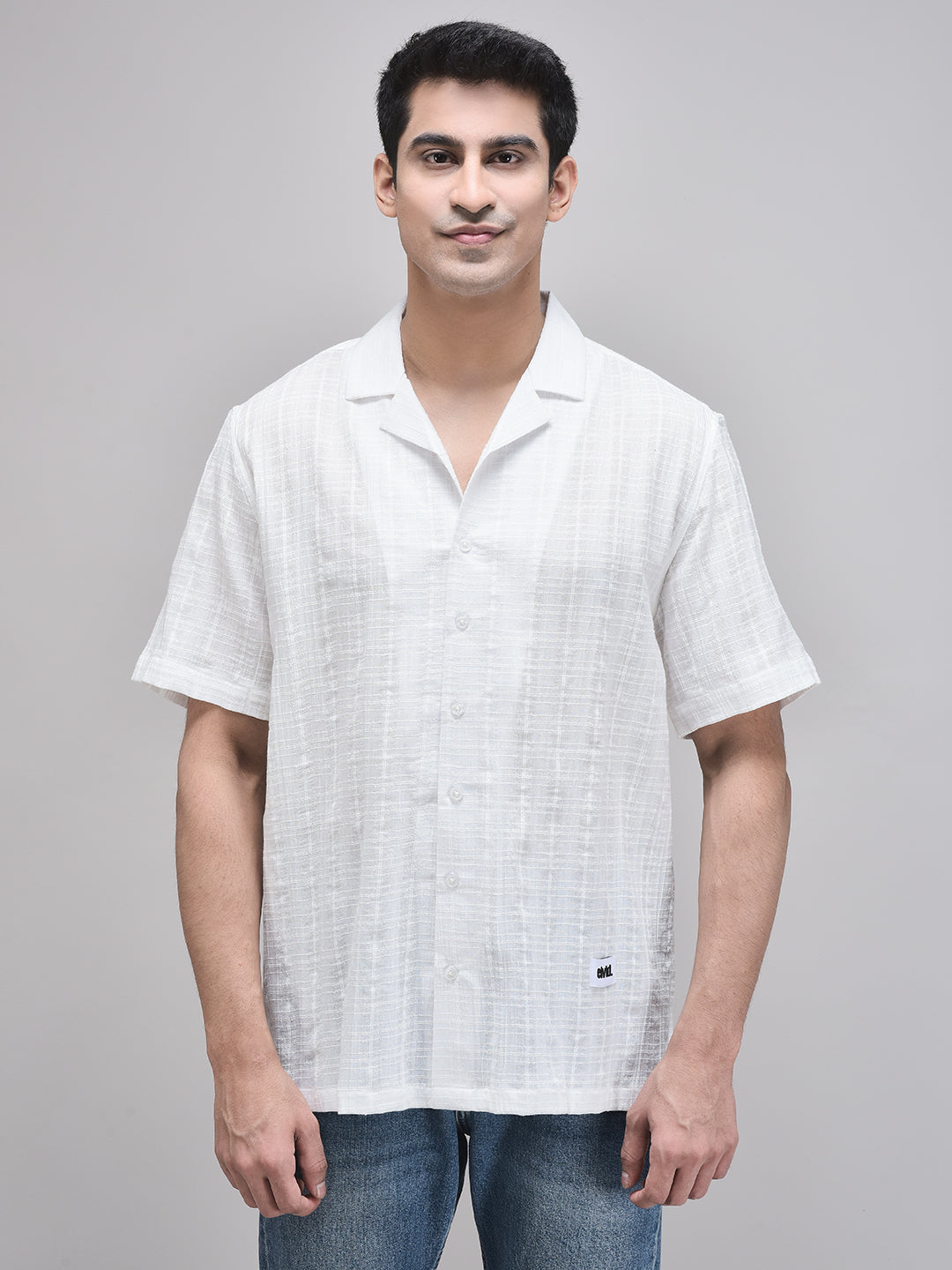 Front view of man wearing white cotton oversized shirt with camp collar – standing straight