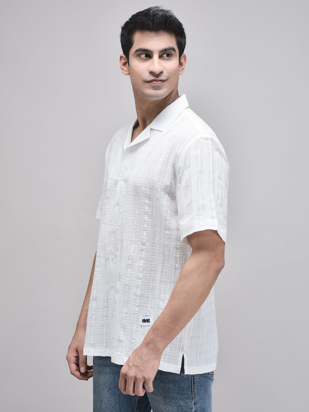 Man facing slightly forward in white short sleeve cotton shirt – relaxed pose