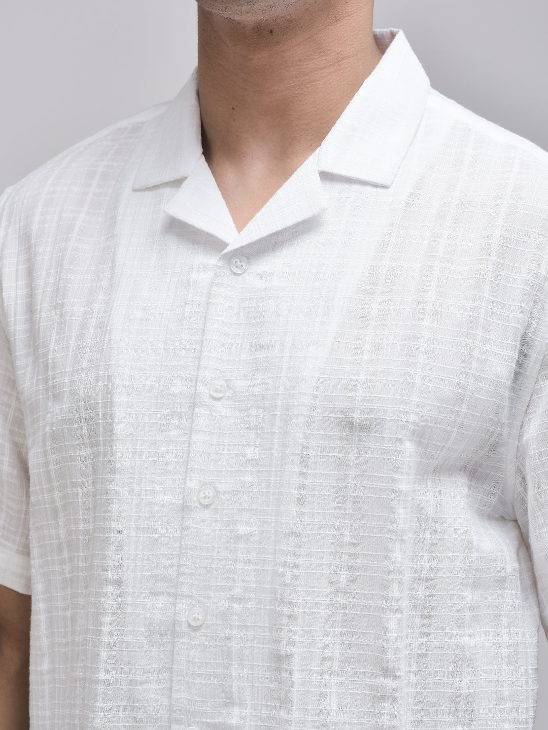 Close-up of camp collar and textured cotton fabric – white breathable summer shirt