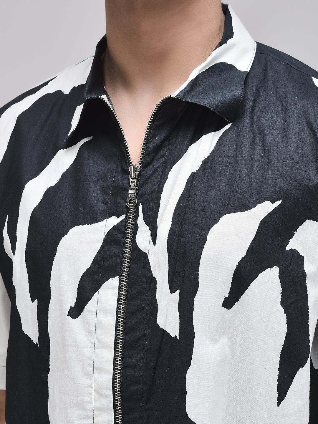 Close-up of zippered collar and bold black brushstroke print – cotton poplin fabric