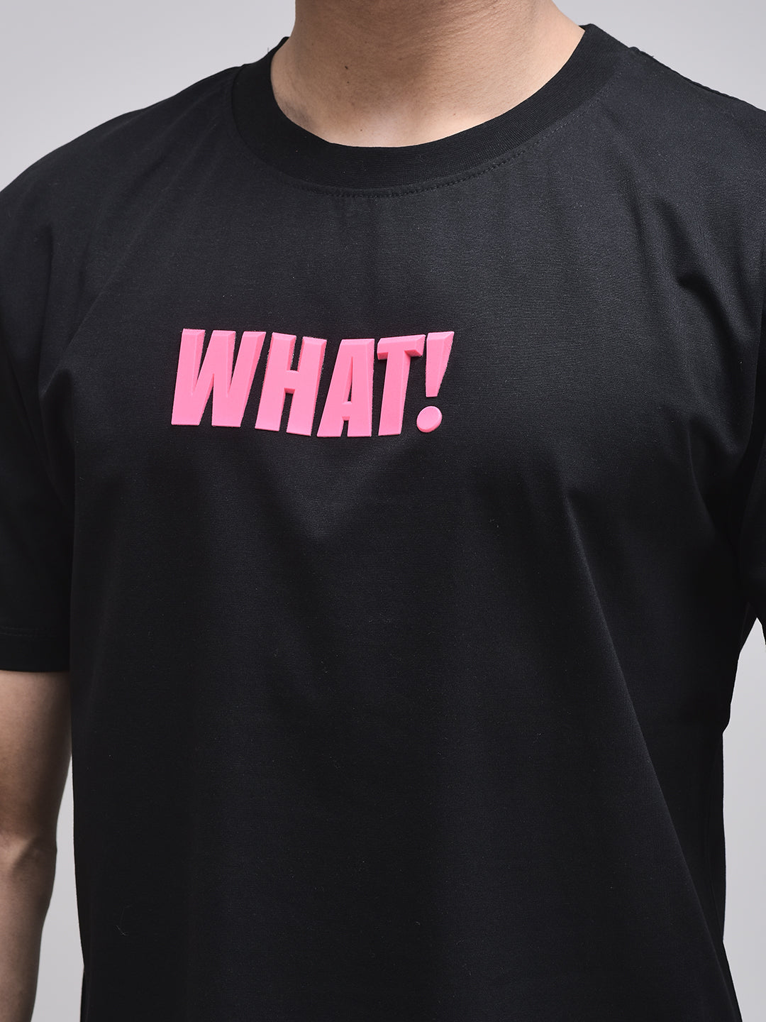 Bold WHAT! typography on oversized black graphic tee – cotton texture