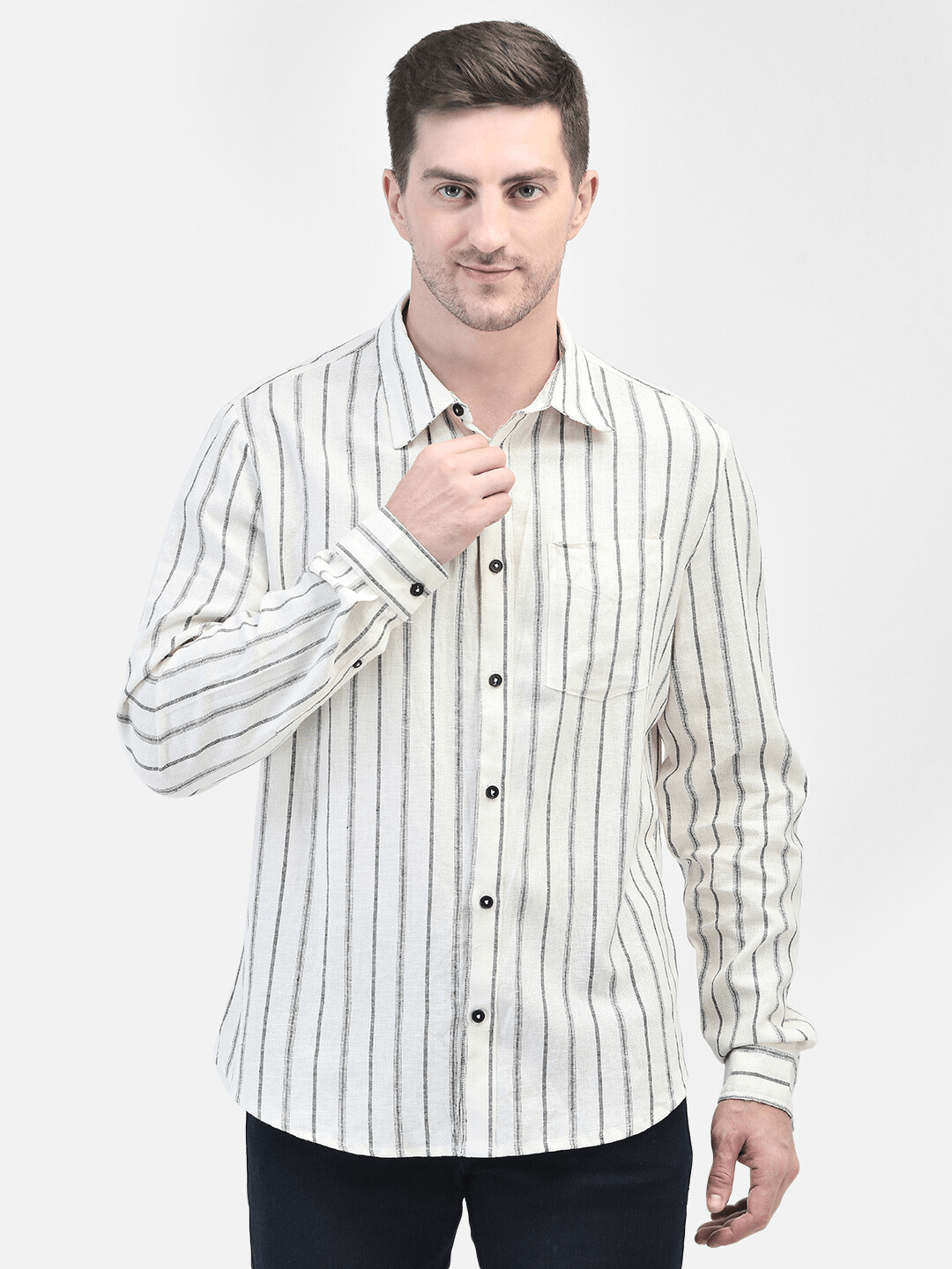 Casual pose of man wearing off-white striped linen shirt