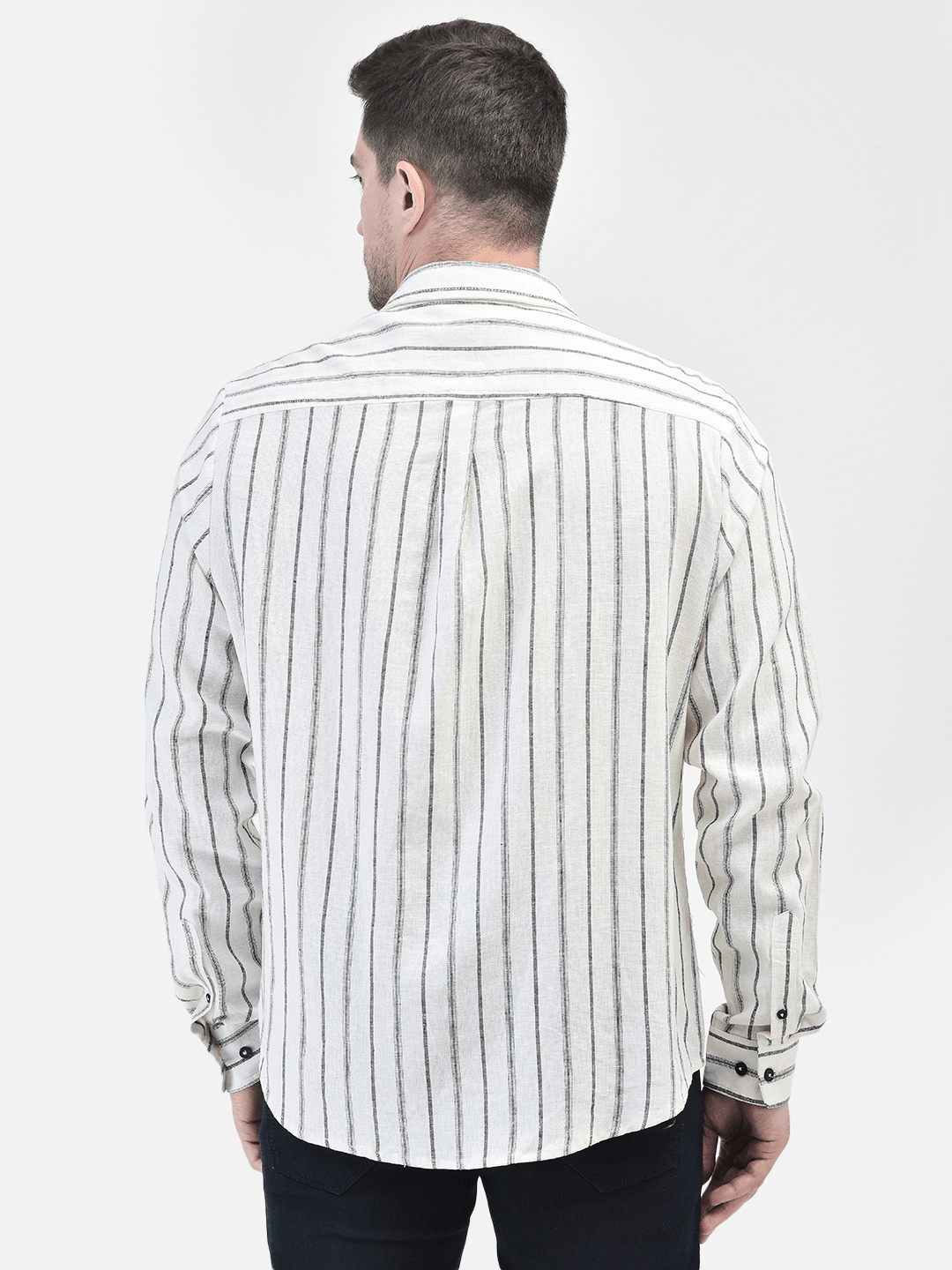 Rear view of off-white shirt with vertical black stripes and straight hem
