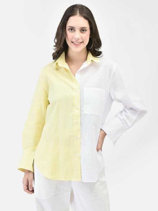 Front view of woman in pastel yellow seersucker shirt – hands on hip