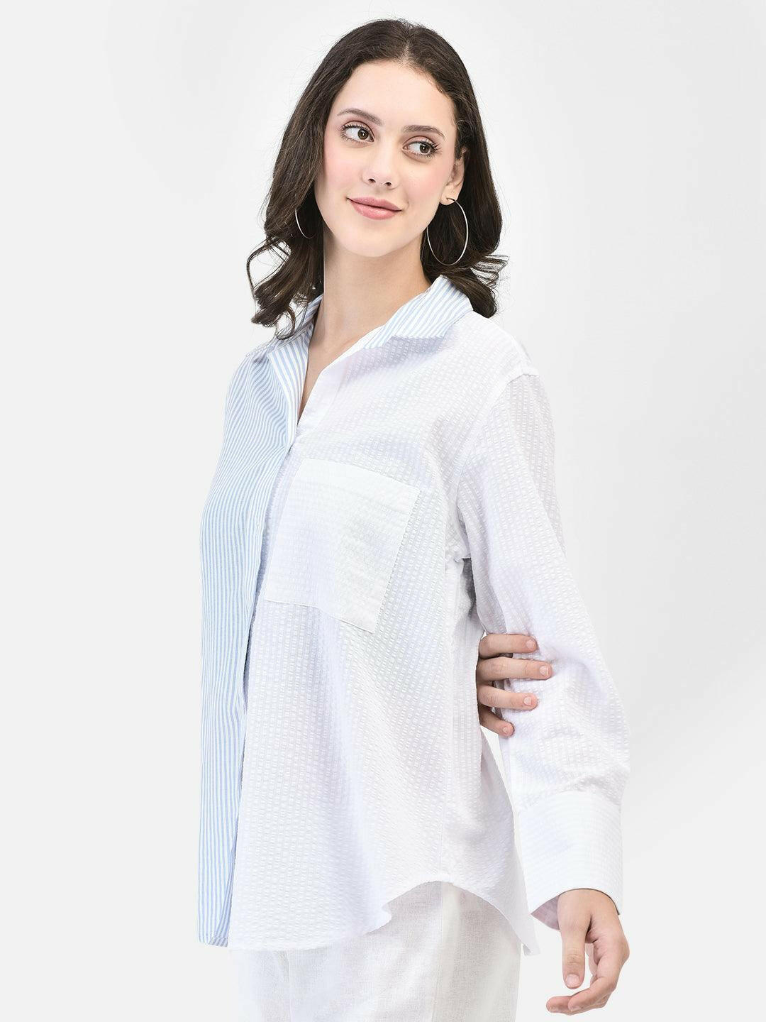 Three-quarter front view – oversized cotton shirt styled casually with white bottoms