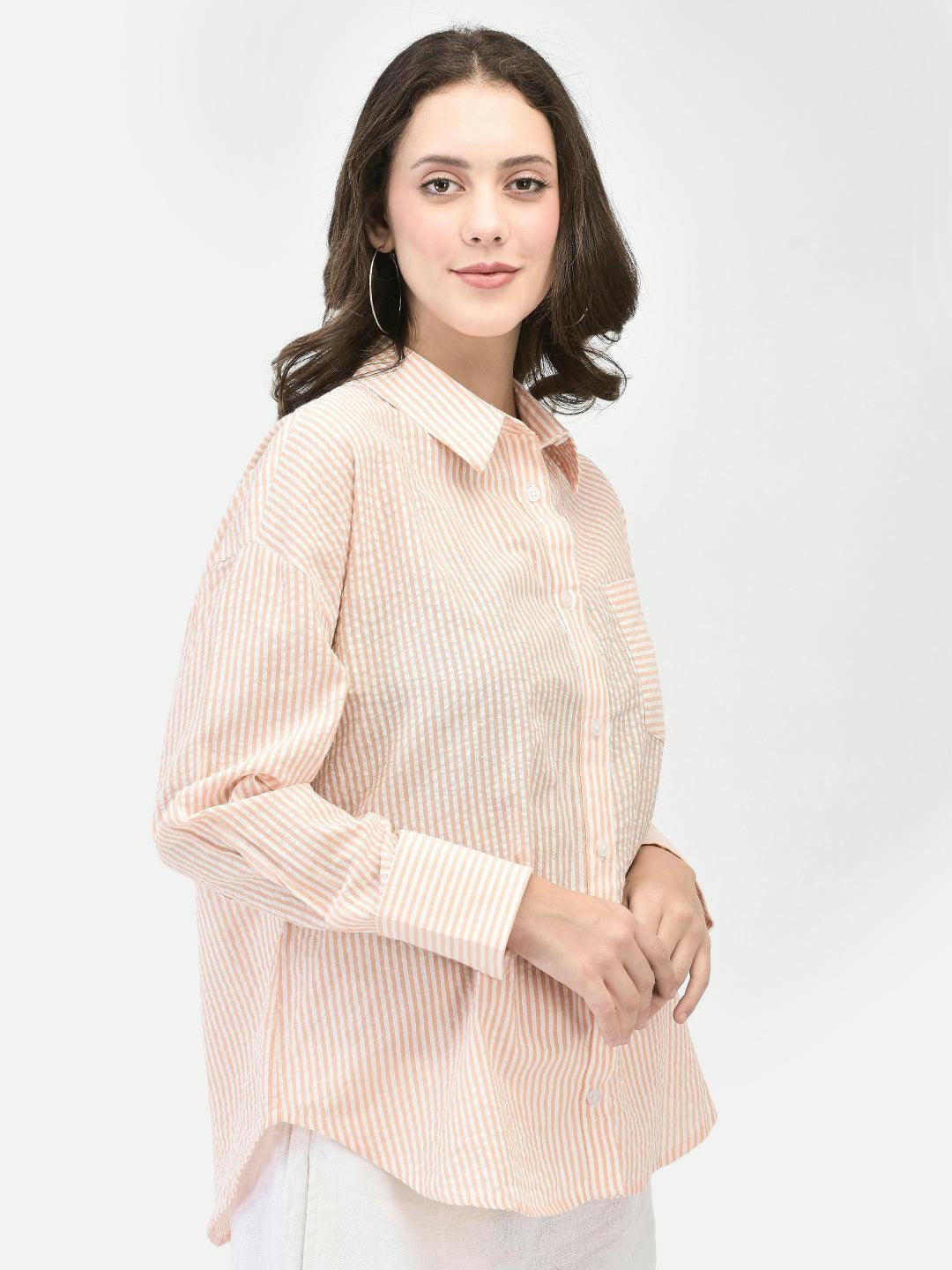Side angle of woman wearing peach textured shirt – lightweight summer shirt