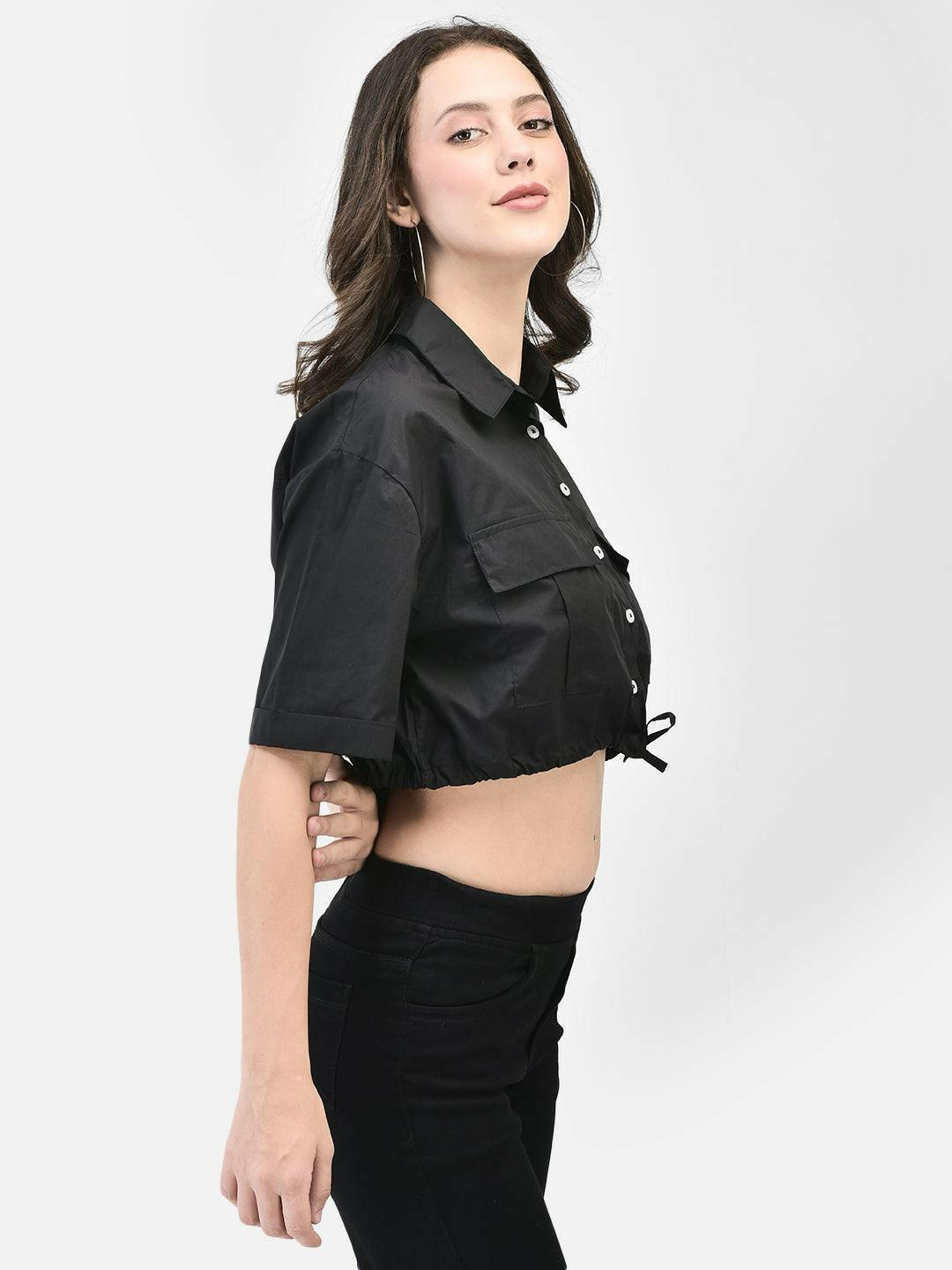 Model showcasing the cropped hem and short sleeves in black shirt