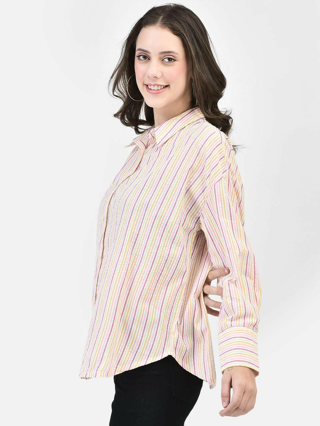 Side view of woman in oversized pink striped shirt – casual relaxed fit
