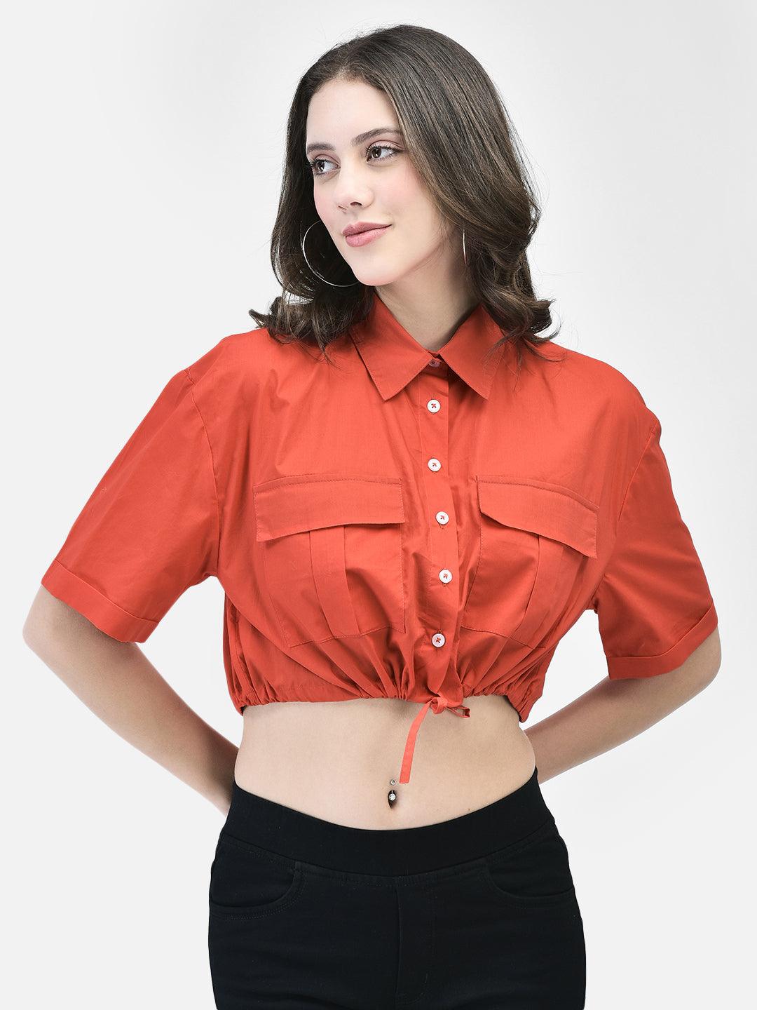 Front view of woman wearing crimson cotton crop shirt with dual chest pockets