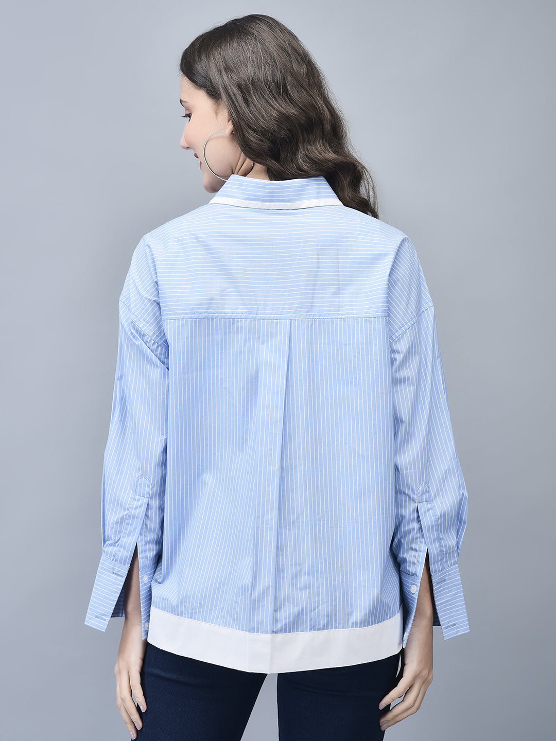 Back view of blue pinstripe shirt with long sleeves and curved hem
