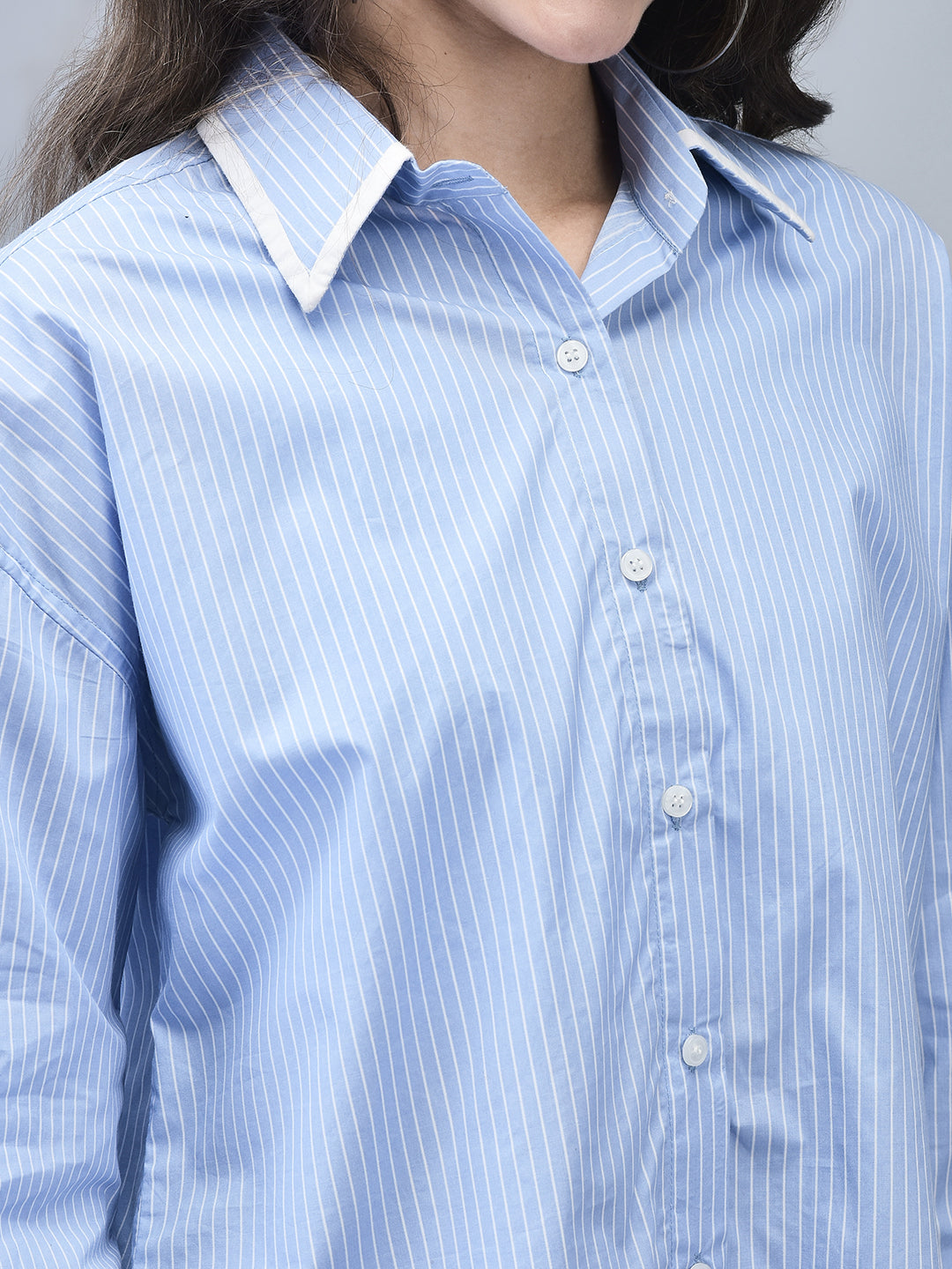 Close-up of shirt collar and pinstripe detailing in blue cotton shirt