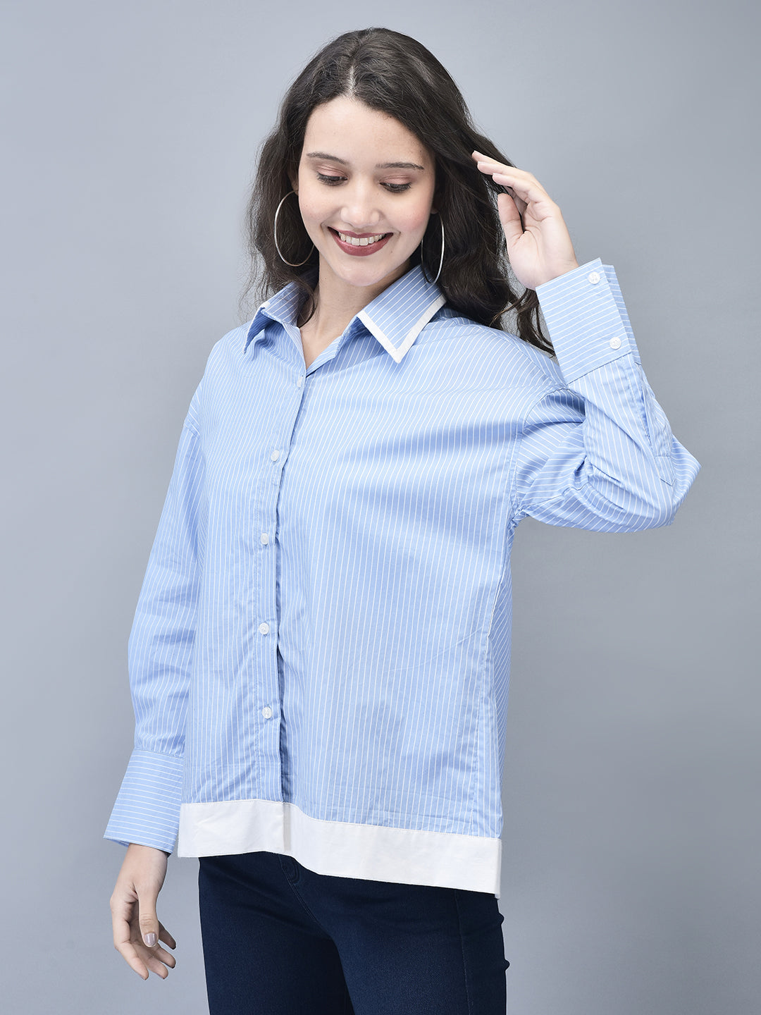 Model showcasing the shirt with hand on head in playful pose