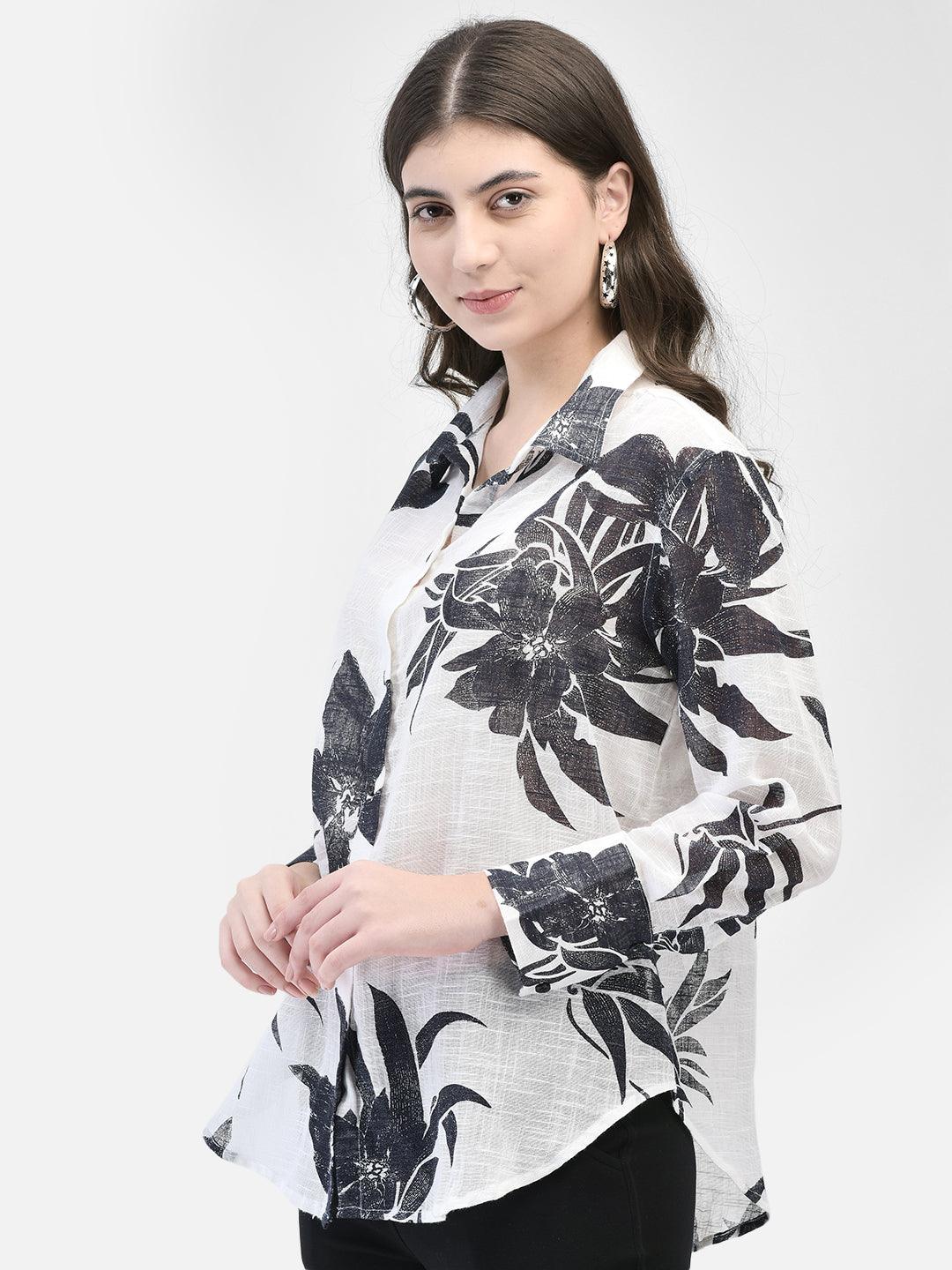 Side pose of woman in black floral print shirt for women