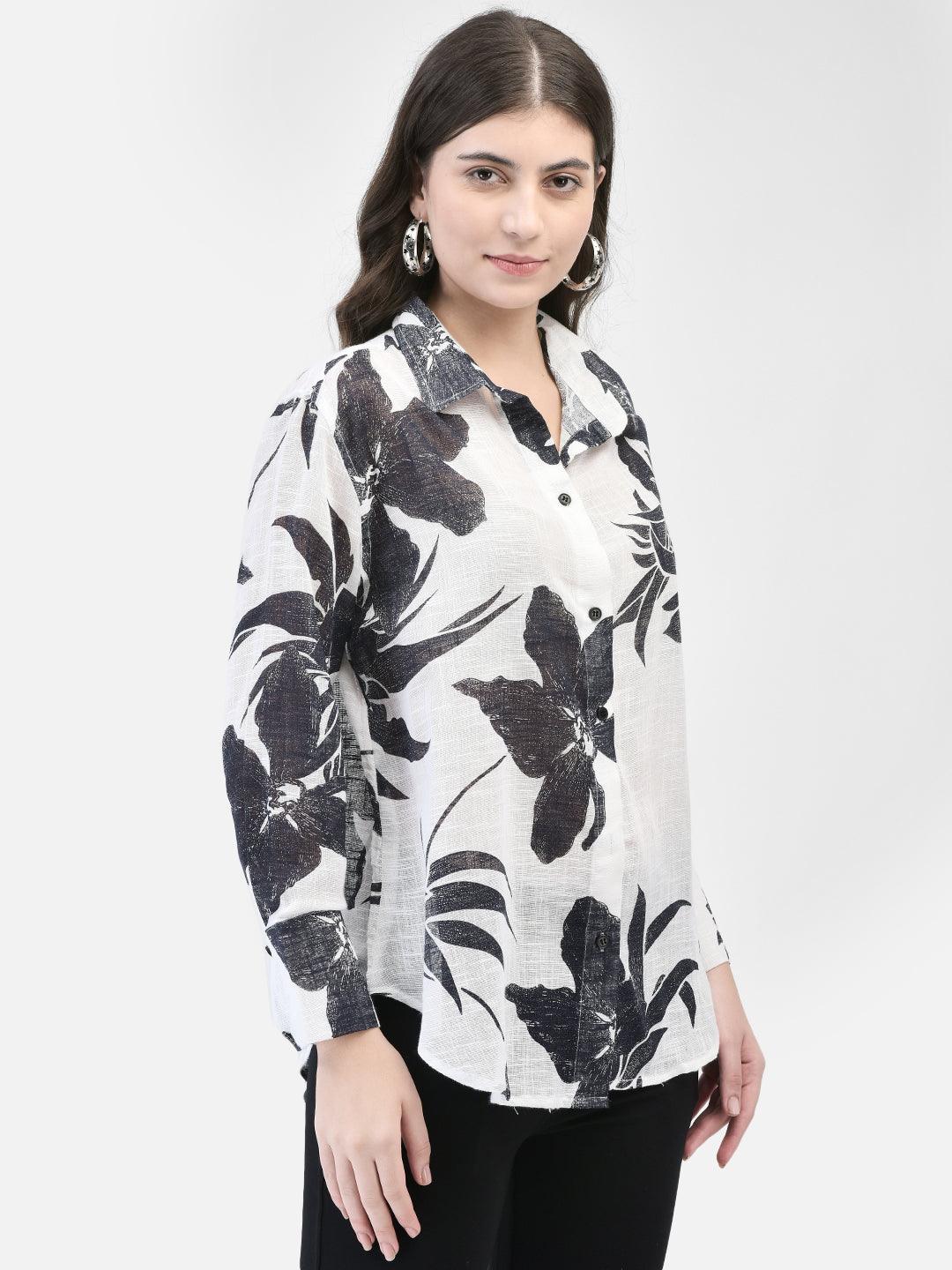 Model showing side profile in white shirt with large black flower design