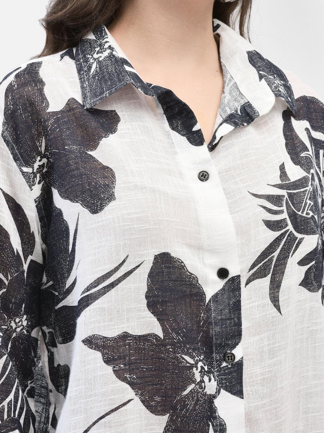 Close-up of shirt collar and bold floral pattern in black on white cotton