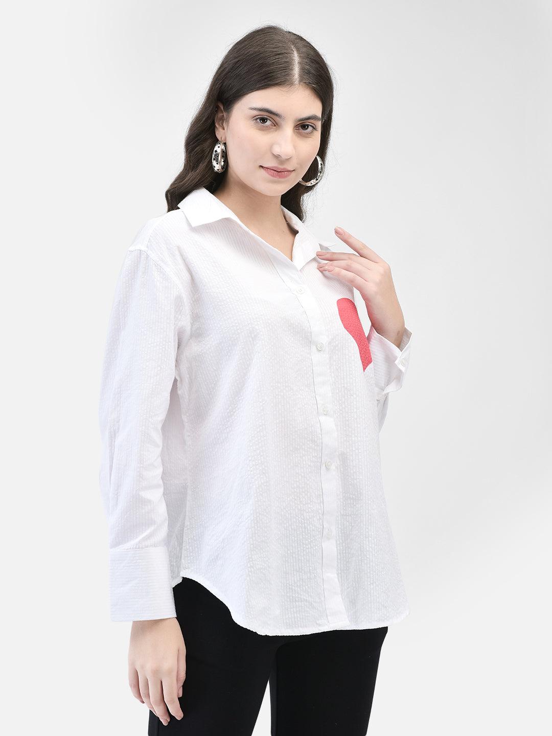 Side profile of model highlighting the shirt’s relaxed fit and heart design
