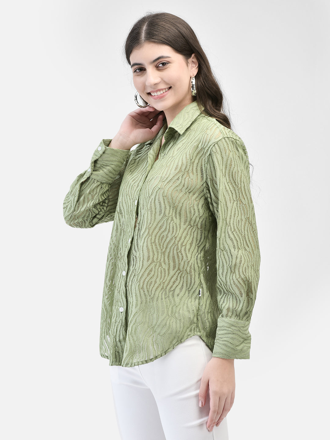 Side pose of model in green textured party shirt, looking confident