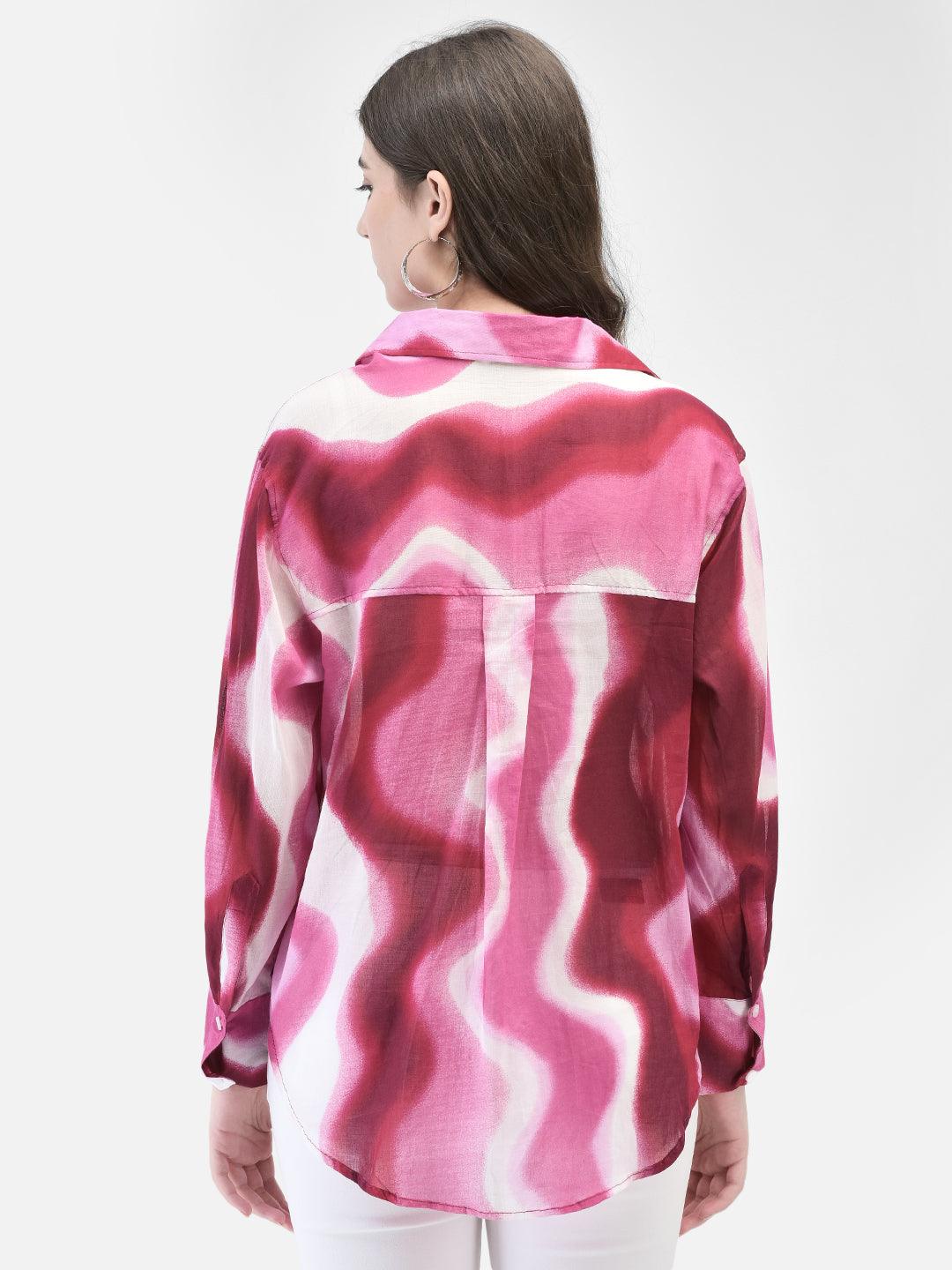 Back view of woman in pink and white abstract print shirt