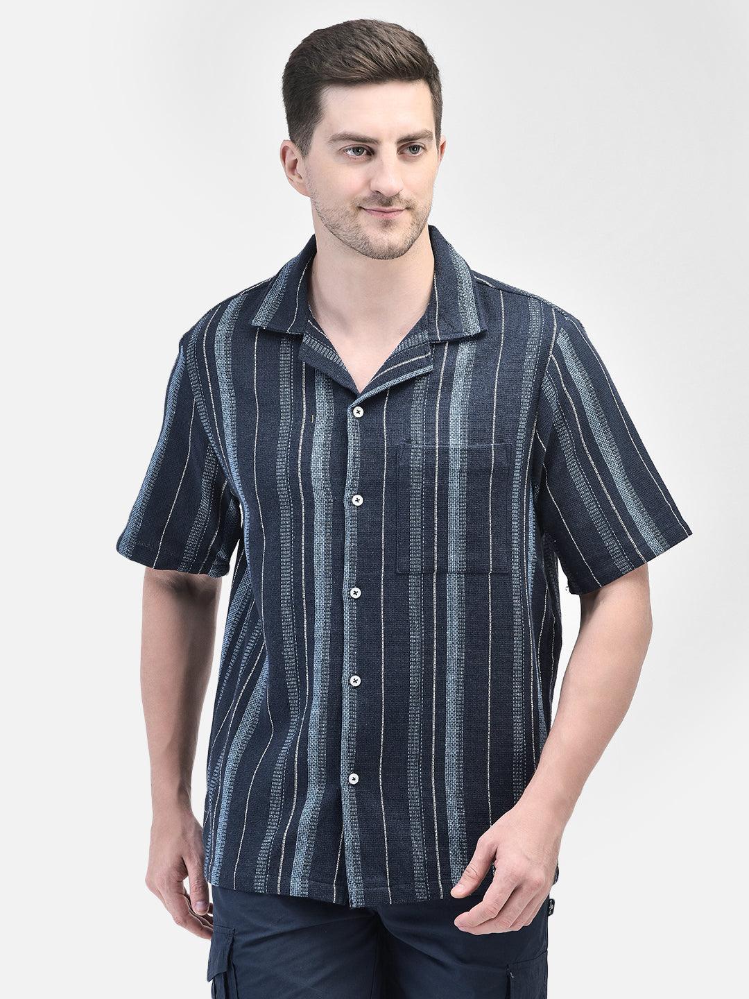 Front view of man standing in navy striped shirt – casual summer outfit