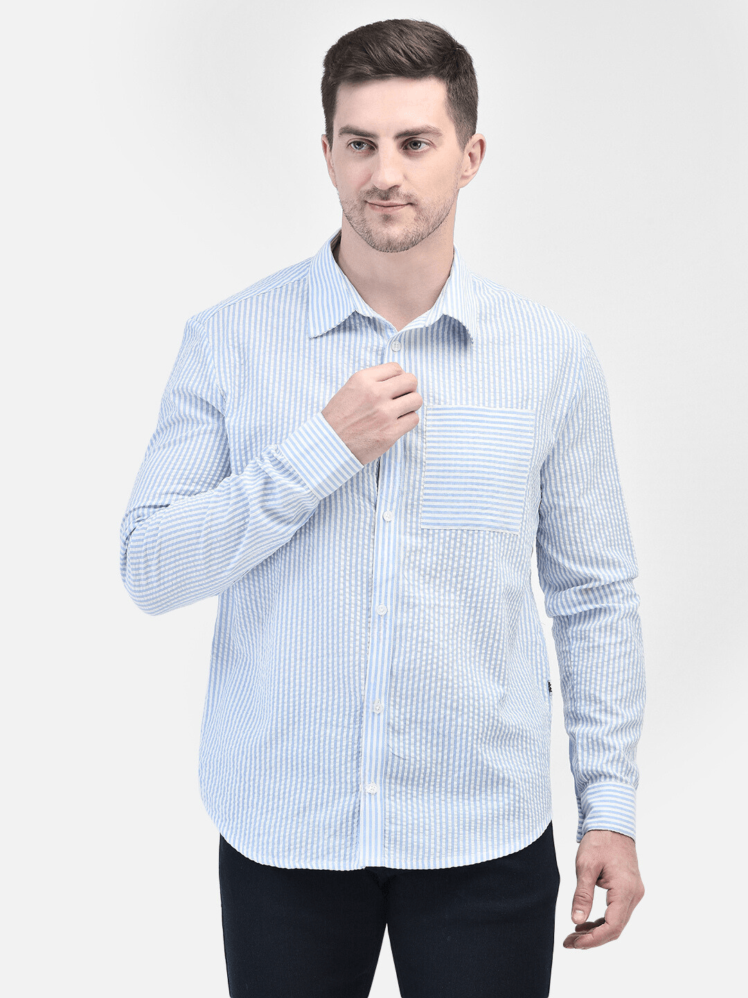 Men’s blue striped cotton shirt – hands adjusting front button