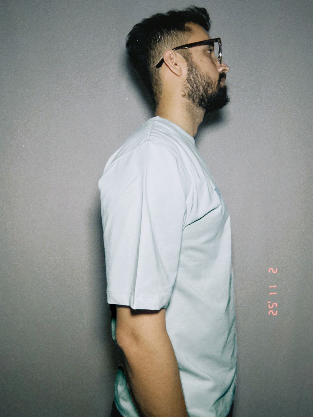 Person wearing a light blue shirt against a gray background