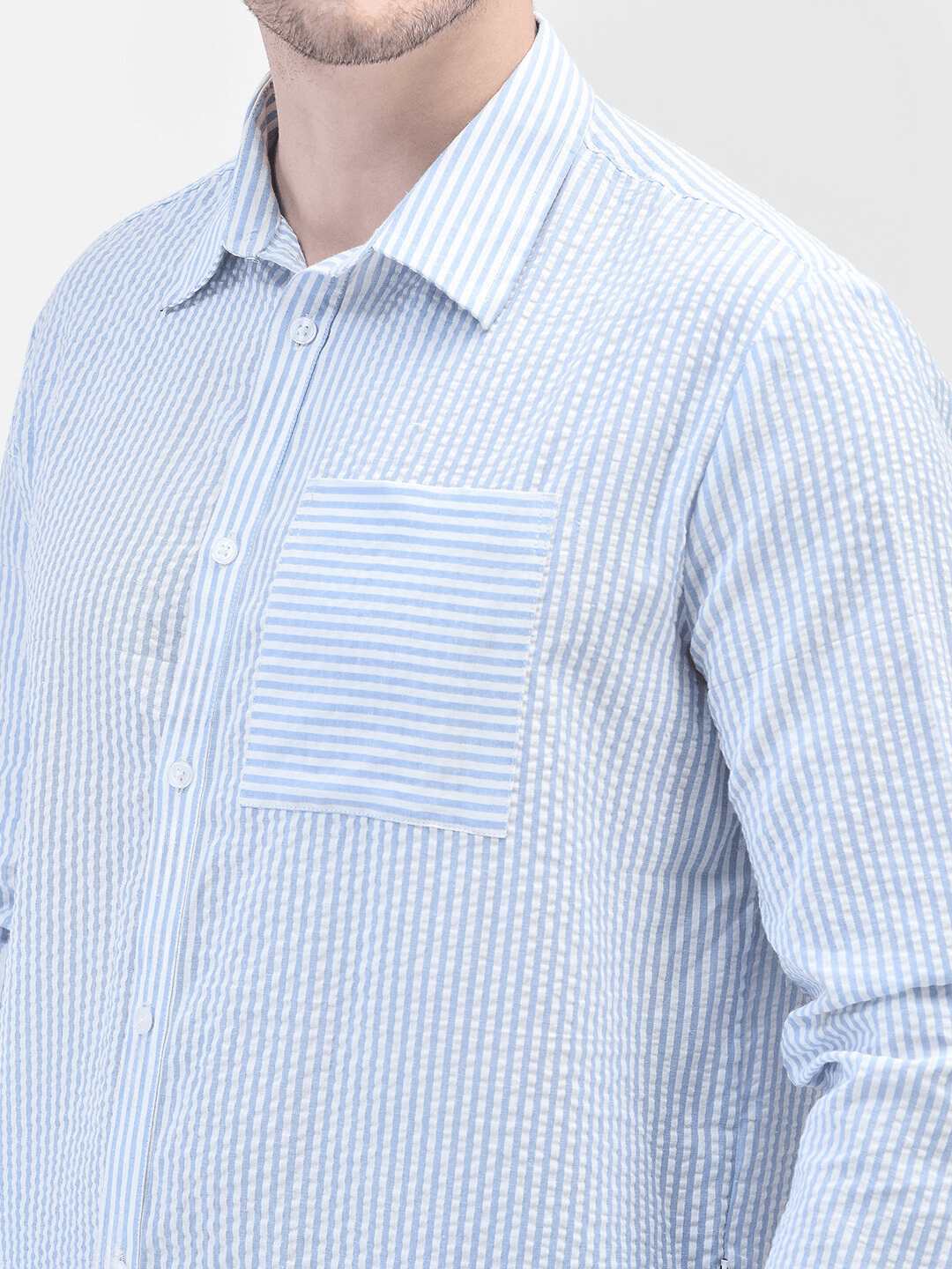 Close-up of collar and chest pocket – blue seersucker textured shirt