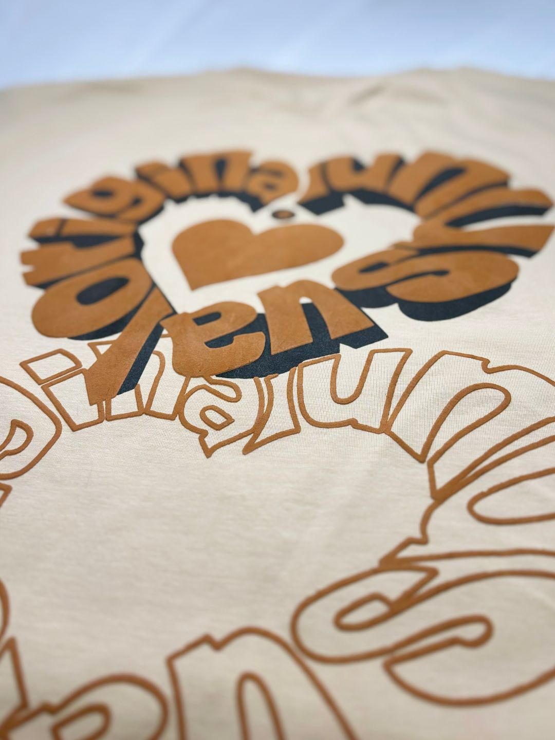 Close-up of a printed design on a product with text and heart shape.