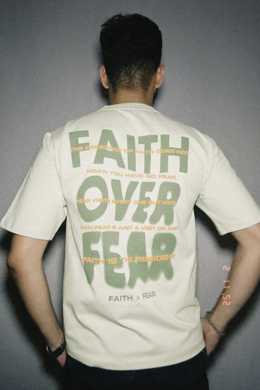 Person wearing a t-shirt with 'Faith Over Fear' text on the back.