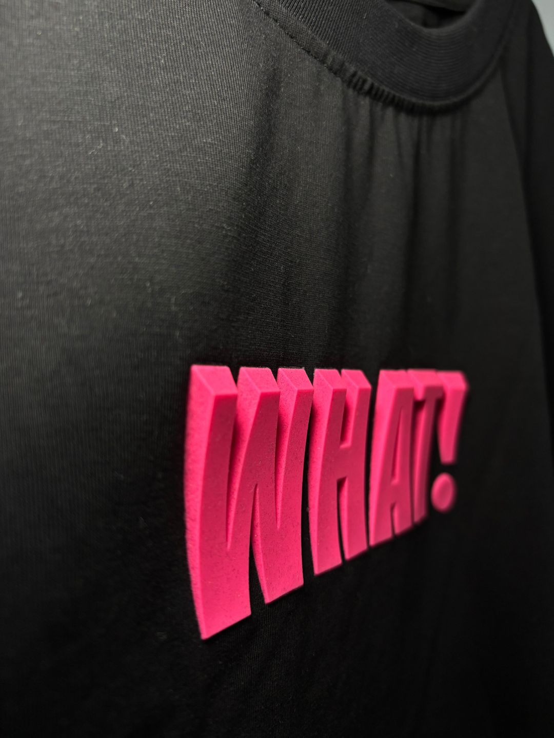 3D WHAT! text print close-up on black cotton t-shirt